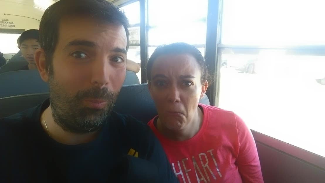 Darcee and Eric riding a bus to a Spartan Mud Run where they almost died